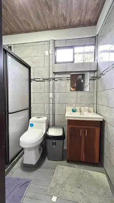 a bathroom with a toilet and a sink at Casa Selva Viva in Uvita