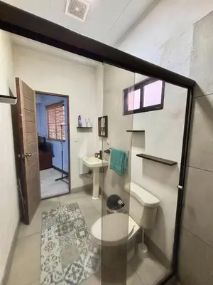 a bathroom with a toilet and a sink at Los Yoses Loft - Ideal for Long Stays in San Jose in San José