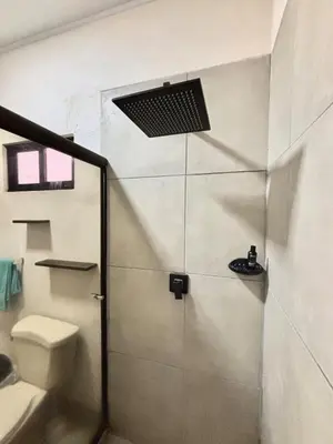 a bathroom with a shower and a toilet at Los Yoses Loft - Ideal for Long Stays in San Jose in San José