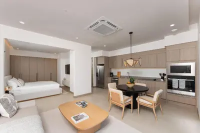 a living room with a bed and a dining room at Cielo de Coco at Naumi, Ocean Views & Beach Club in Sardinal