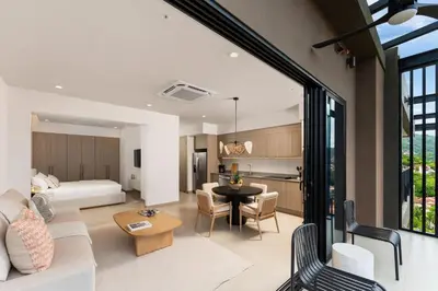 a living room with a bed and a dining room at Cielo de Coco at Naumi, Ocean Views & Beach Club in Sardinal