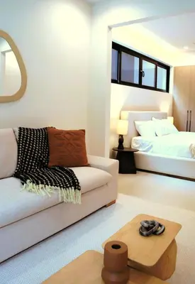 a living room with a couch and a bed at Brisa del Valle at Naumi, Ocean Views & Beach Club in Sardinal