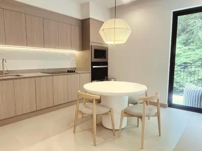a kitchen with a white table and two chairs at Brisa del Valle at Naumi, Ocean Views & Beach Club in Sardinal
