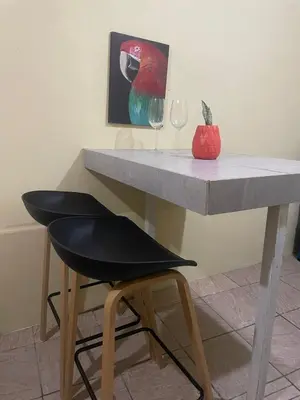 a table with a chair and a wine glass at Quiet cabin 10 minutes from the sea in Nicoya