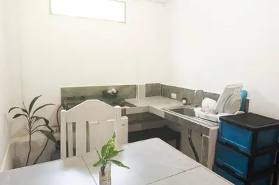 a kitchen with a sink and a table at Quiet cabin 10 minutes from the sea in Nicoya