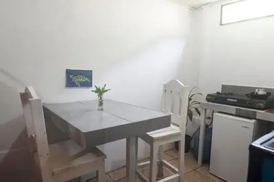 a kitchen with a table and two chairs and a stove at Quiet cabin 10 minutes from the sea in Nicoya