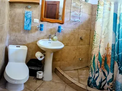 a bathroom with a toilet and a sink at Tico Tiki Vacation Villa - Epic View & Pool, 5 Minute walk to beach! in Sámara