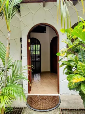 an open door to a house with plants at Tico Tiki Vacation Villa - Epic View & Pool, 5 Minute walk to beach! in Sámara