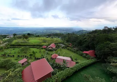 an aerial view of a resort with red roofs at Cabañas Caeli, El Colibri, NEW La Fortuna Rainforest Cabin w Panoramic Views in San Francisco