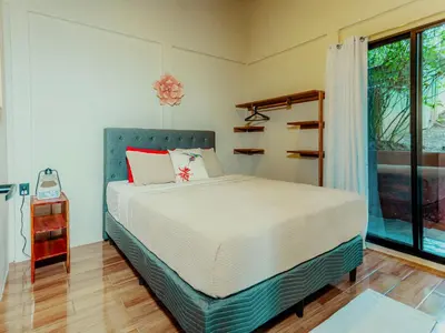a bedroom with a bed and a large window at Cabañas Caeli, El Colibri, NEW La Fortuna Rainforest Cabin w Panoramic Views in San Francisco