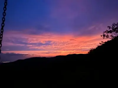 a sunset with a mountain in the background at Villa Arcoiris in San Ramón