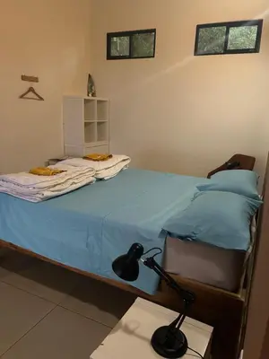 a bedroom with a bed with a lamp on it at Villa Arcoiris in San Ramón