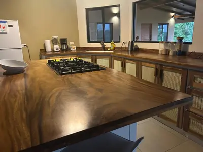 a kitchen with a wooden counter top with a stove at Villa Arcoiris in San Ramón