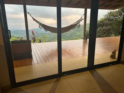 a view of a porch with a hammock in a house at Villa Arcoiris in San Ramón