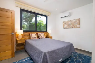 a bedroom with a bed and a window at CasaBlanca with Pool, 5 min from the Ocean in Cuajiniquil