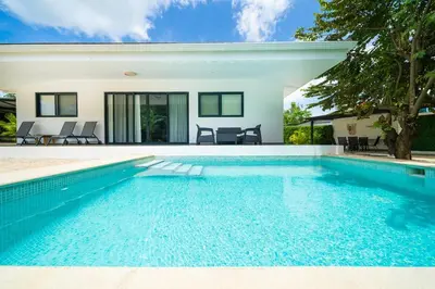 a swimming pool in front of a house at CasaBlanca with Pool, 5 min from the Ocean in Cuajiniquil