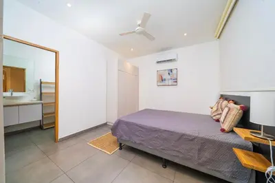 a bedroom with a bed and a mirror and a sink at CasaBlanca with Pool, 5 min from the Ocean in Cuajiniquil