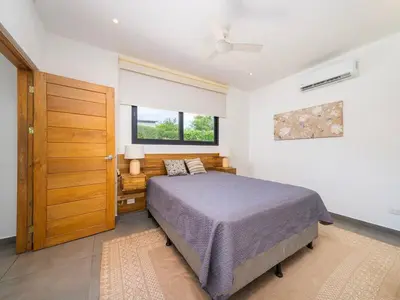 a bedroom with a bed and a window at CasaBlanca with Pool, 5 min from the Ocean in Cuajiniquil