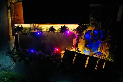 an aerial view of a backyard with christmas lights at Arenal Palms Hot Springs in Chachagua