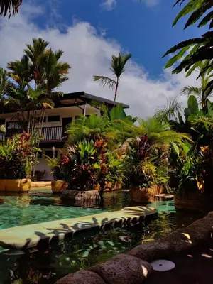 a swimming pool in front of a resort at Arenal Palms Hot Springs in Chachagua