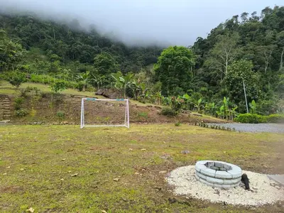 a soccer ball in a field with a goal at Pacayitas El Camino House in Turrialba
