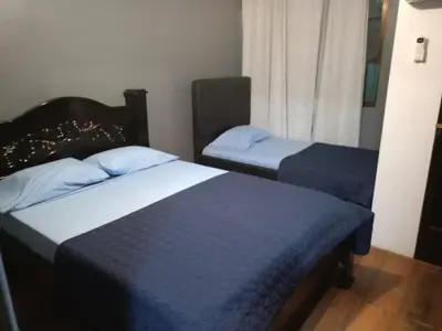 a bedroom with two beds and a window at Harmony Retreat in Fortuna