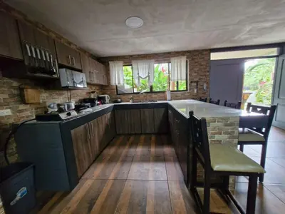 a kitchen with a island in the middle of a room at Harmony Retreat in Fortuna