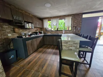 a kitchen with a table and chairs in a room at Harmony Retreat in Fortuna