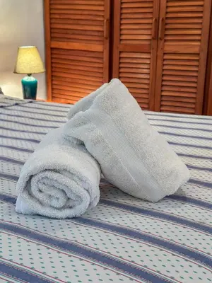 a white towel sitting on top of a bed at Apt 33 Best Ocean Views Hilltop Oasis in Tamarindo