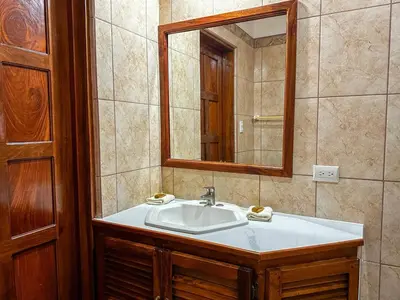 a bathroom with a sink and a mirror at Apt 47 Hilltop Retreat Ocean Garden Views in Tamarindo