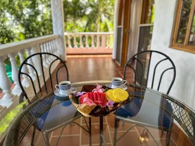 a glass table with a bowl of fruit on it at Apt 47 Hilltop Retreat Ocean Garden Views in Tamarindo