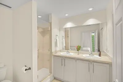a bathroom with two sinks and a shower at Palma Serena Condo, Resort Pools & Near Coco Beach in Coco