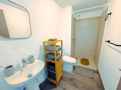 a bathroom with a sink and a toilet and a shower at Stunning Sunset View Apartment with Free Parking in San José