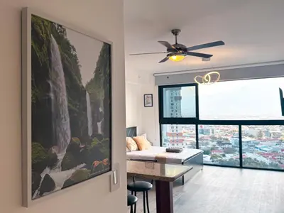 a living room with a large painting on the wall at Stunning Sunset View Apartment with Free Parking in San José