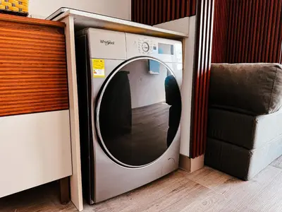 a washing machine in a room with a chair at Stunning Sunset View Apartment with Free Parking in San José