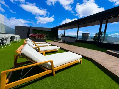 a group of lounge chairs on the roof of a building at Stunning Sunset View Apartment with Free Parking in San José