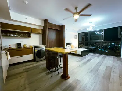 a kitchen with a table in the middle of a room at Stunning Sunset View Apartment with Free Parking in San José