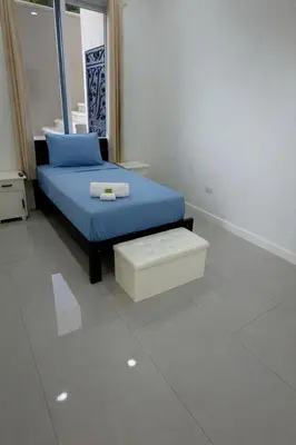 a bedroom with a blue bed and a stool at Luxury 4BR home with Infinity Pool & firepit in Playa Hermosa