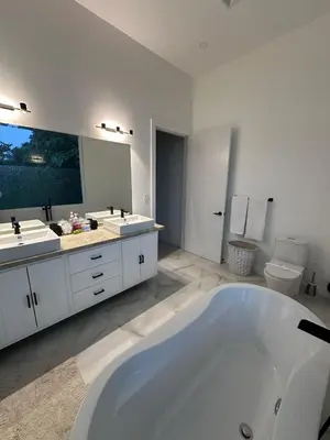 a large bathroom with two sinks and a tub at Luxury 4BR home with Infinity Pool & firepit in Playa Hermosa