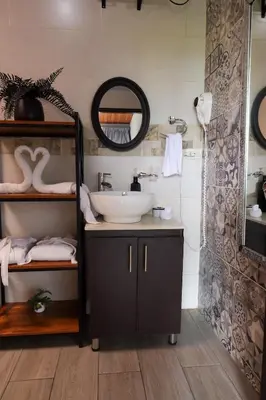 a bathroom with a sink and a mirror at Volcano & Lake View Oasis with Scenic Tub in El Castillo de La Fortuna