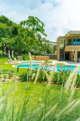 a resort with a swimming pool in a yard at Kamin Casa, Ocean Views & Beach Club in Sardinal