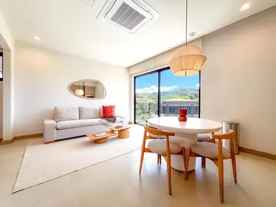 a living room with a table and a couch at Kamin Casa, Ocean Views & Beach Club in Sardinal