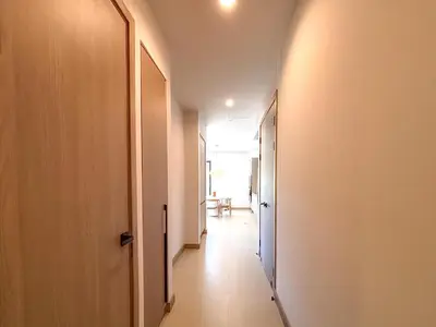 a corridor of a hallway with a door and a table at Kamin Casa, Ocean Views & Beach Club in Sardinal