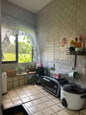 a kitchen with a microwave on a tiled counter at Hidden House Casa Escondida in Santa Rosa