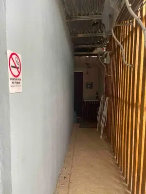 a hallway with a no smoking sign on a wall at Hidden House Casa Escondida in Santa Rosa