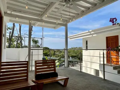 a porch with a bench on a house at Casa Blanca Manuel Antonio A1, Central, Pool, Gated in Manuel Antonio
