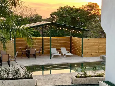 a gazebo with chairs and tables next to a pool at Casa Blanca Manuel Antonio A1, Central, Pool, Gated in Manuel Antonio