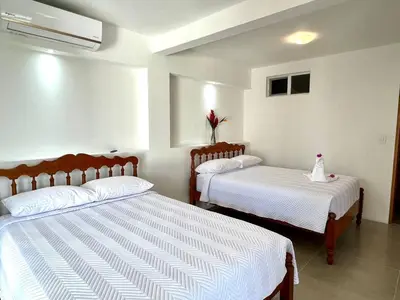 a bedroom with two beds with white sheets at Casa Blanca Manuel Antonio A1, Central, Pool, Gated in Manuel Antonio