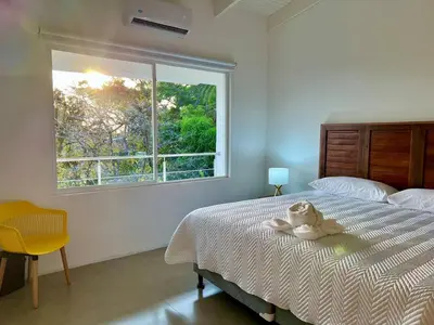 a bedroom with a bed with a teddy bear on it at Casa Blanca Manuel Antonio B2, Central, Pool, Gated in Manuel Antonio