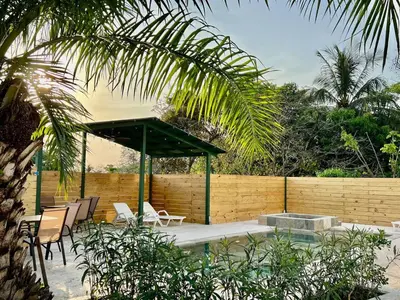 a patio with a table and chairs and a fence at Casa Blanca Manuel Antonio B1, Central, Pool, Gated in Manuel Antonio